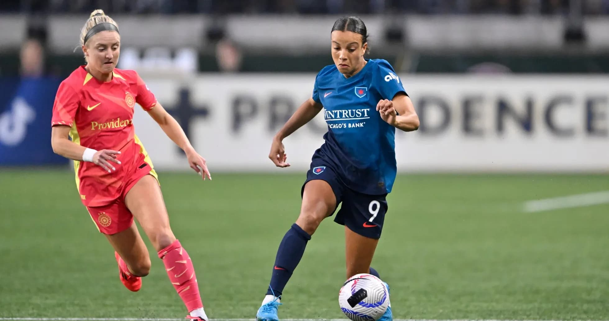 Players competing for the ball in NWSL match