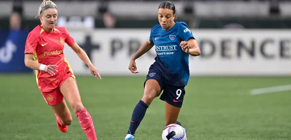 Players competing for the ball in NWSL match