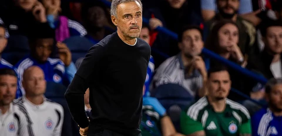 Coach observing match from the sidelines with fans