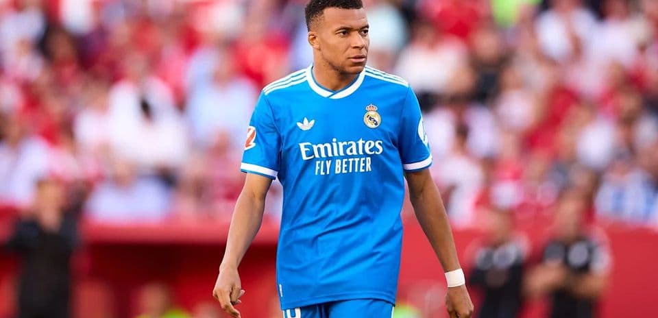 Player in blue kit walking on the pitch