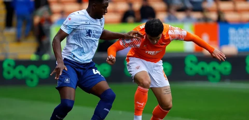 Two players competing for the ball during match