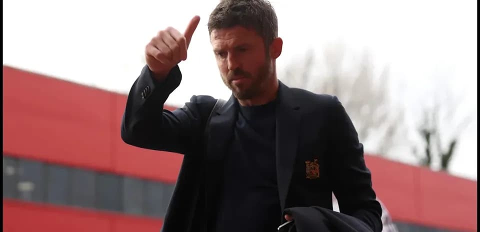 Manager giving a thumbs up outside stadium
