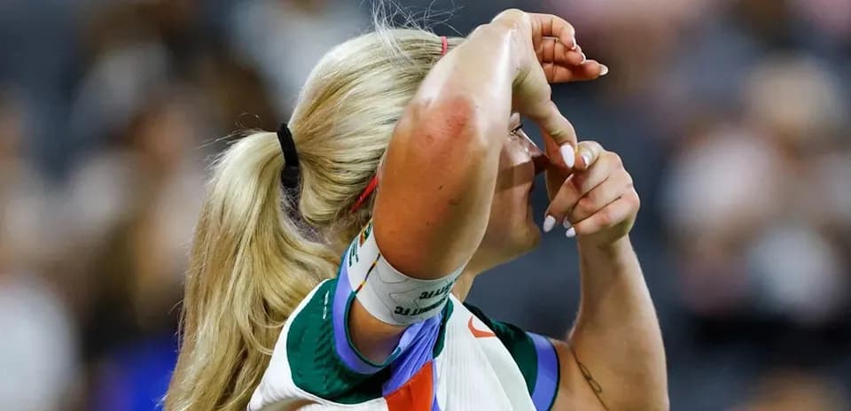 Athlete adjusting her hair during a match