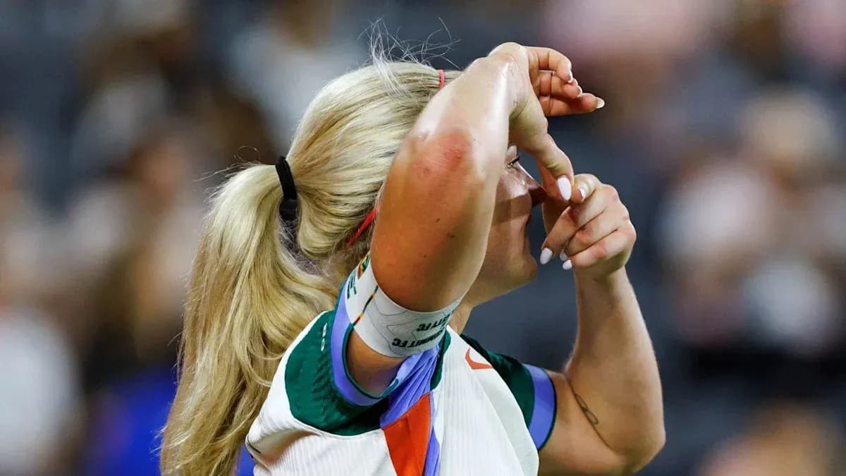 Athlete adjusting her hair during a match