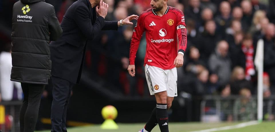 Manager giving instructions to player on sideline