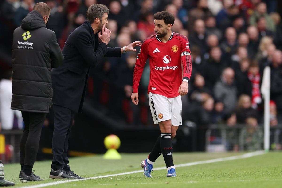 Manager giving instructions to player on sideline