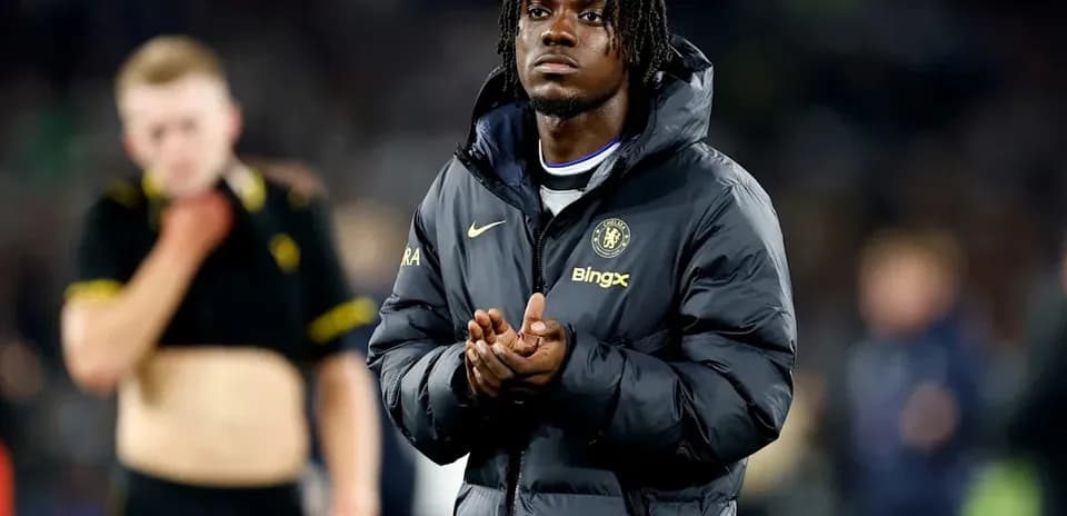Player in Chelsea jacket applauding on the field