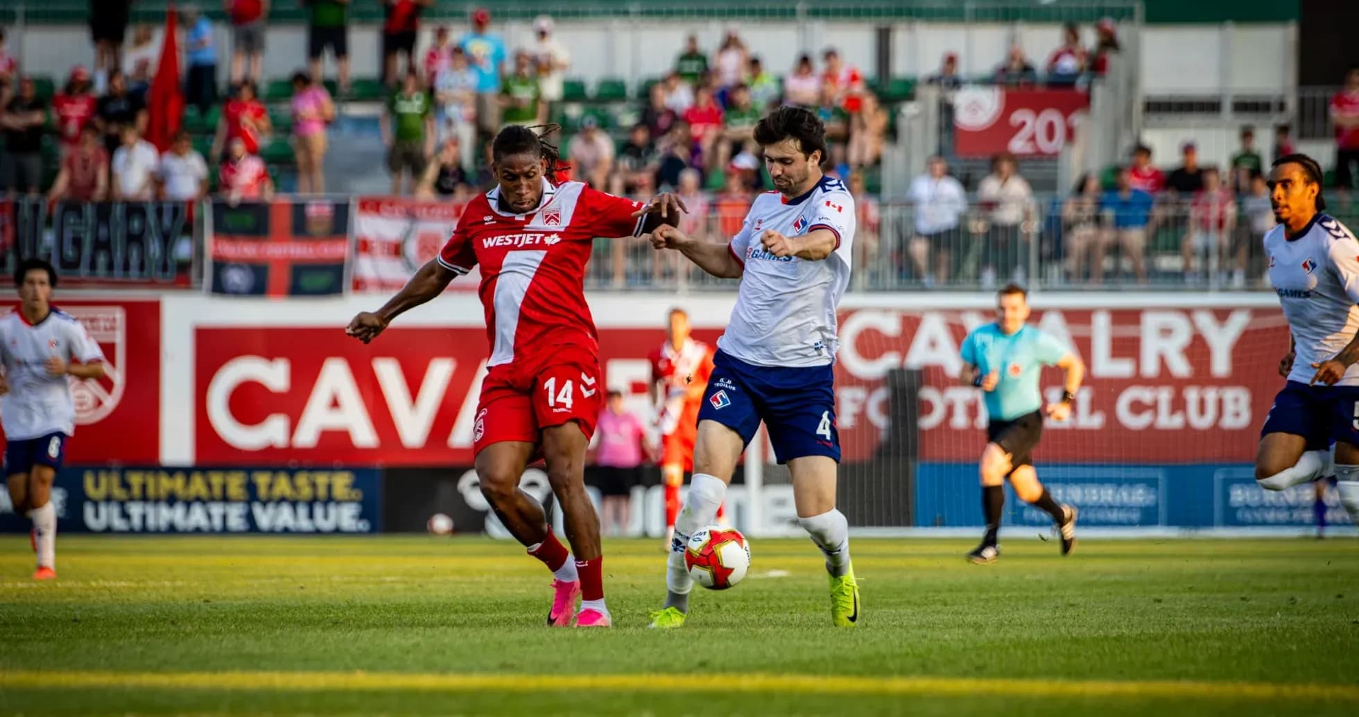 Cavalry FC player battling for the ball