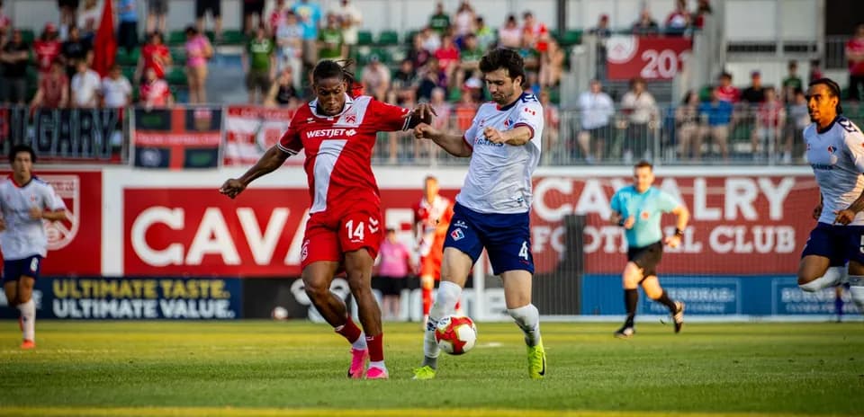 Cavalry FC player battling for the ball