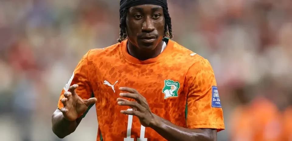 Player warming up in orange jersey during match