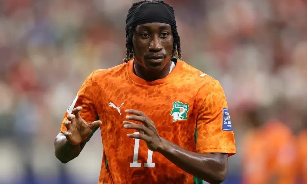 Player warming up in orange jersey during match