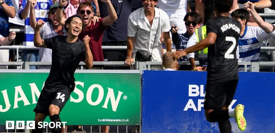 Player celebrating goal with fans in background