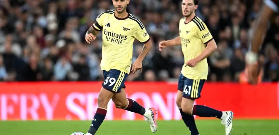 Two Arsenal players running during a match