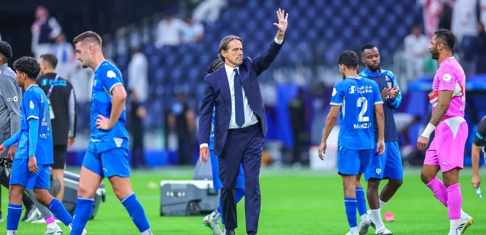 Coach waving to players after the match