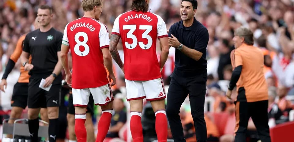 Arsenal players and coach discussing during match