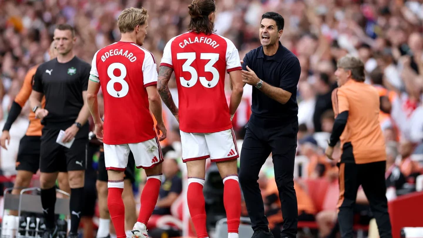 Arsenal players and coach discussing during match