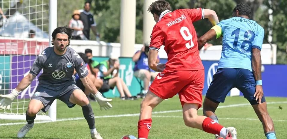Player attempting to score against goalkeeper in match