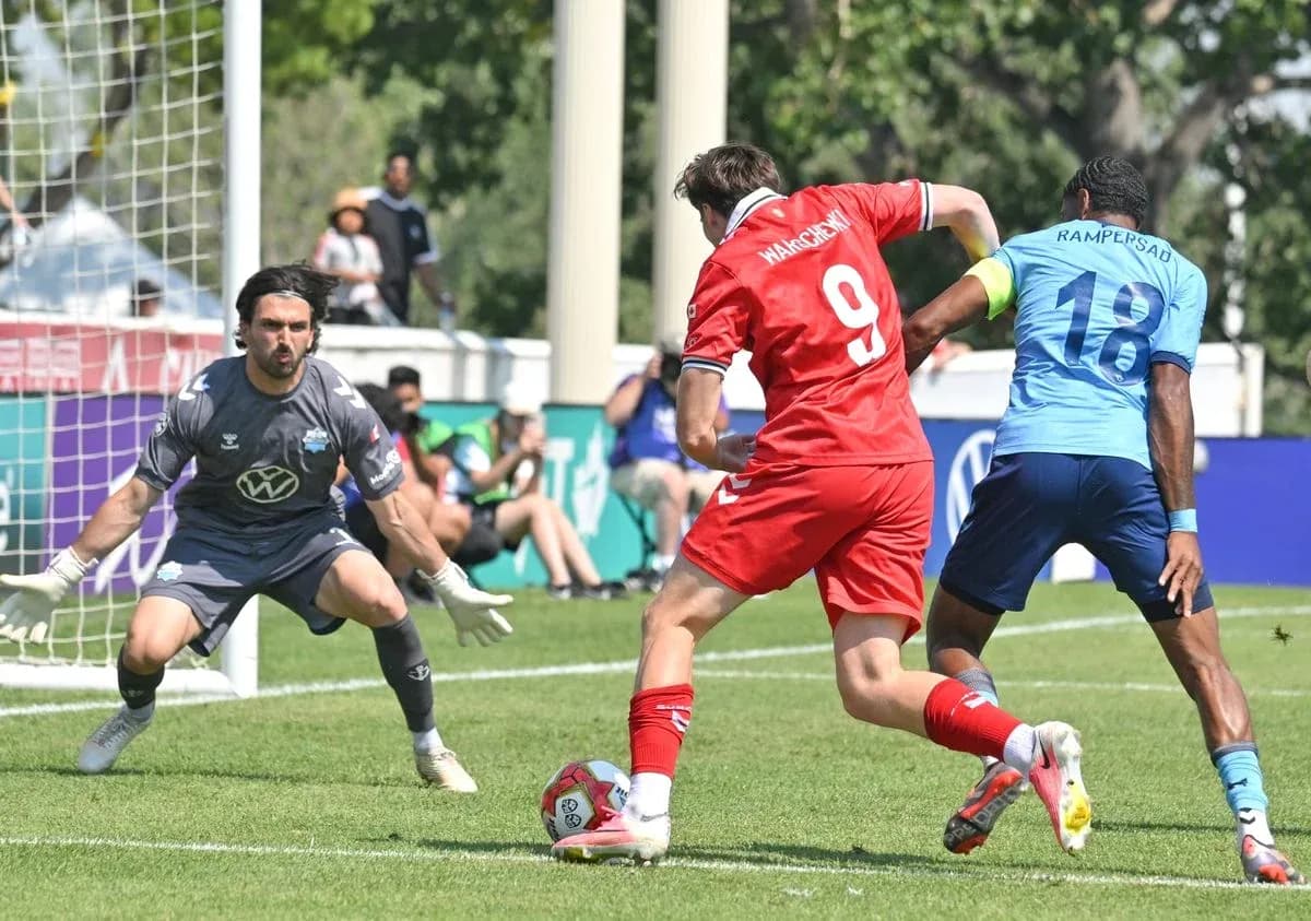 Player attempting to score against goalkeeper in match
