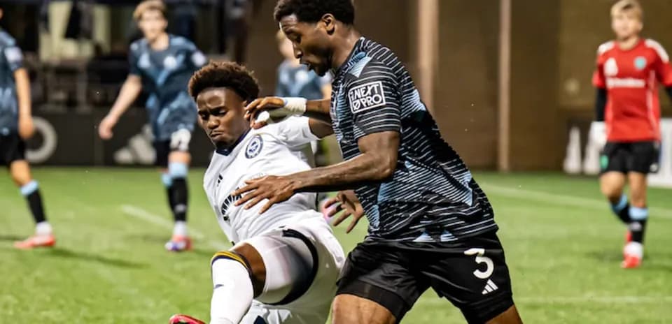 Players contesting for the ball during match