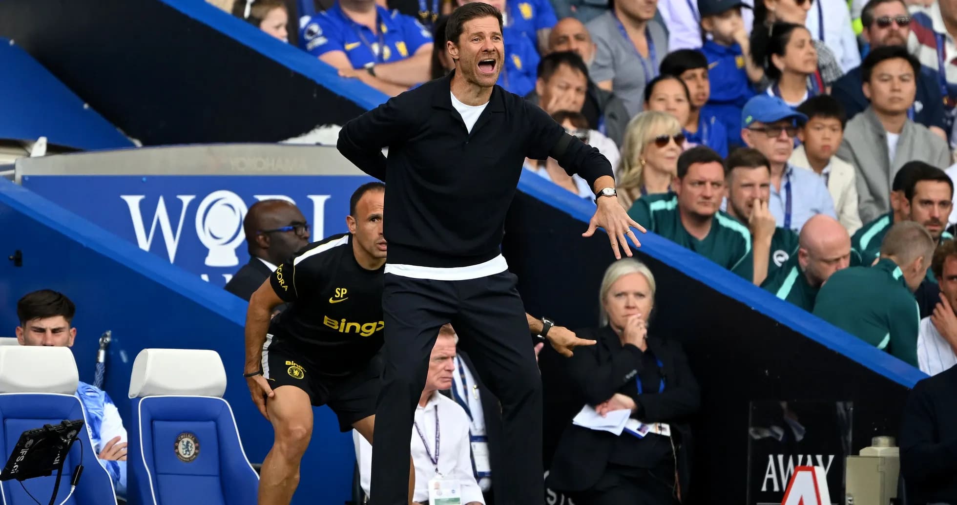 Coach directing players from the sideline during match