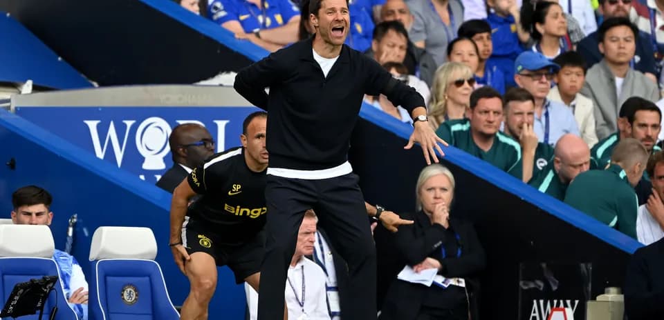 Coach directing players from the sideline during match
