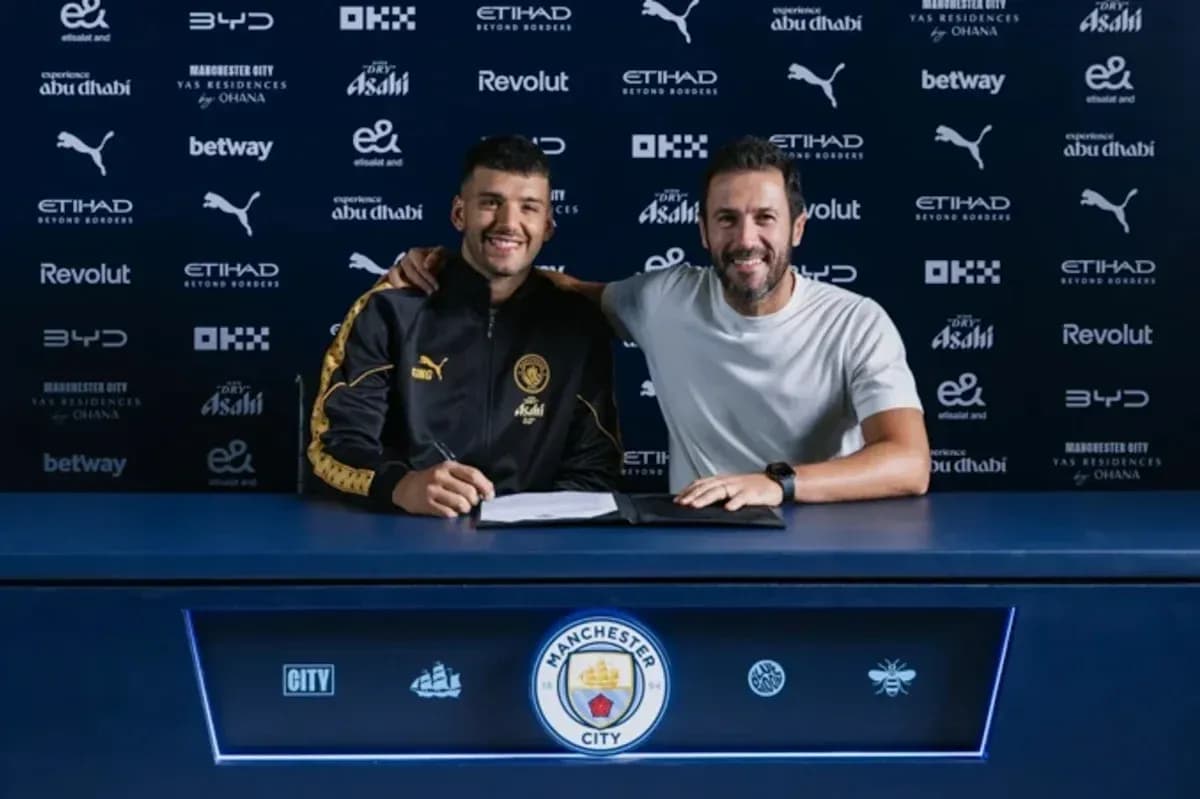 Player and manager signing contract at table