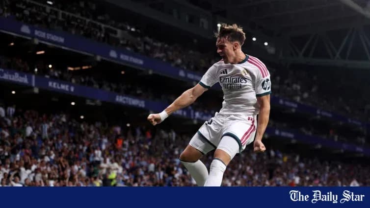 Player celebrating goal in front of cheering crowd
