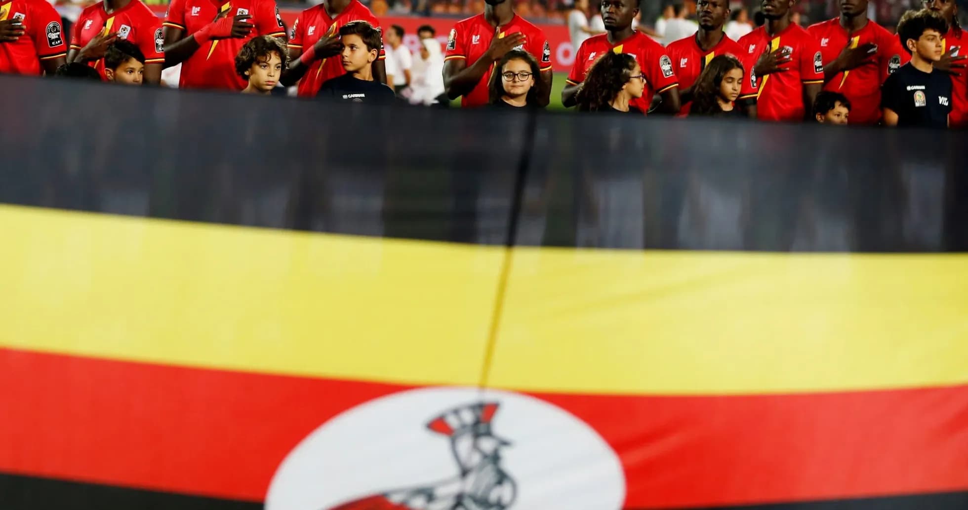 Players standing with national flag before match