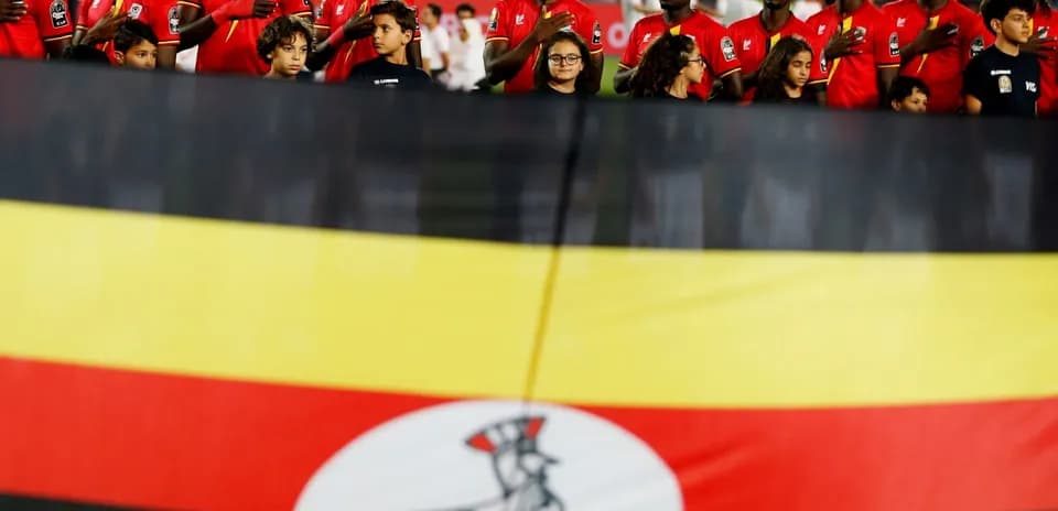 Players standing with national flag before match