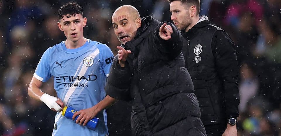 Pep Guardiola giving instructions to Phil Foden