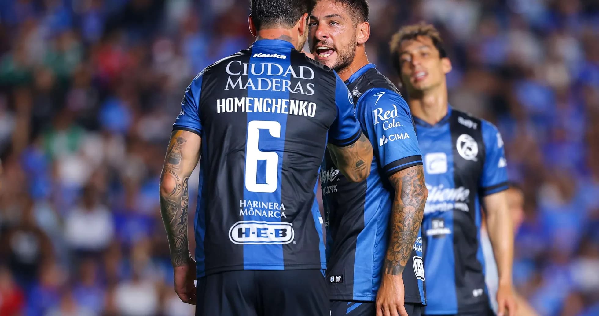Players from Queretaro celebrating during match