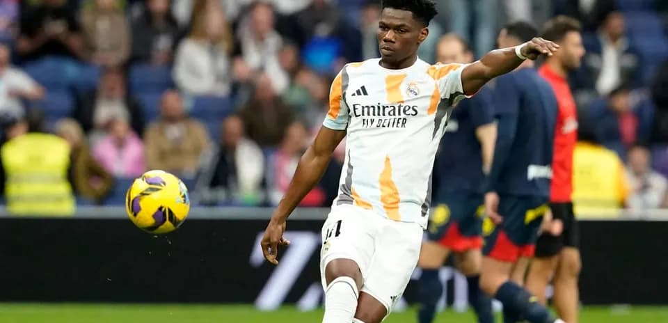 Player in Real Madrid kit passing the ball