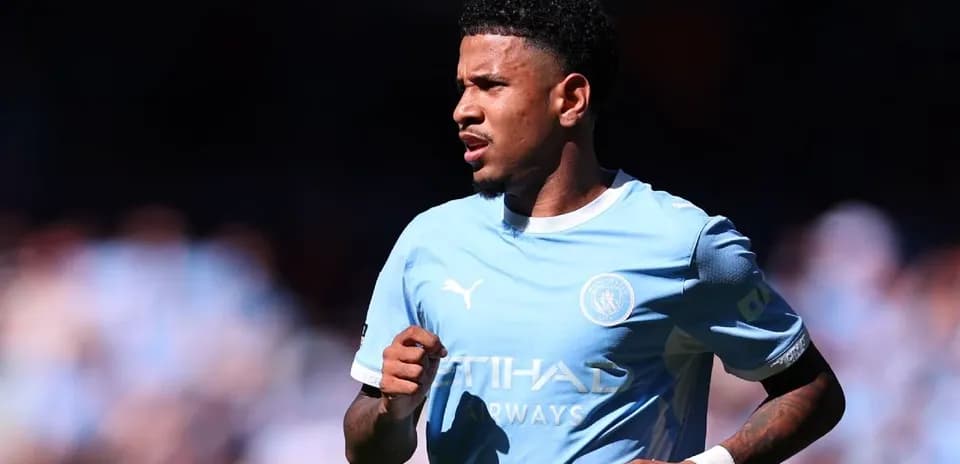 Player running on the field in Manchester City kit