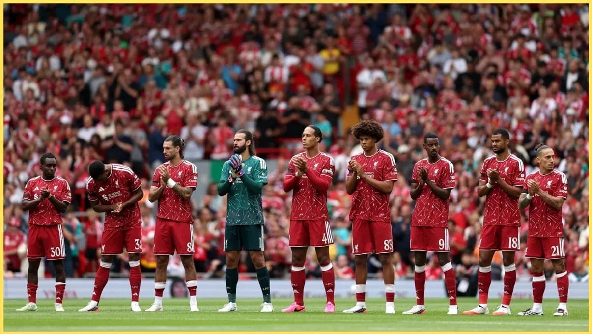 Liverpool players standing in line, applauding fans