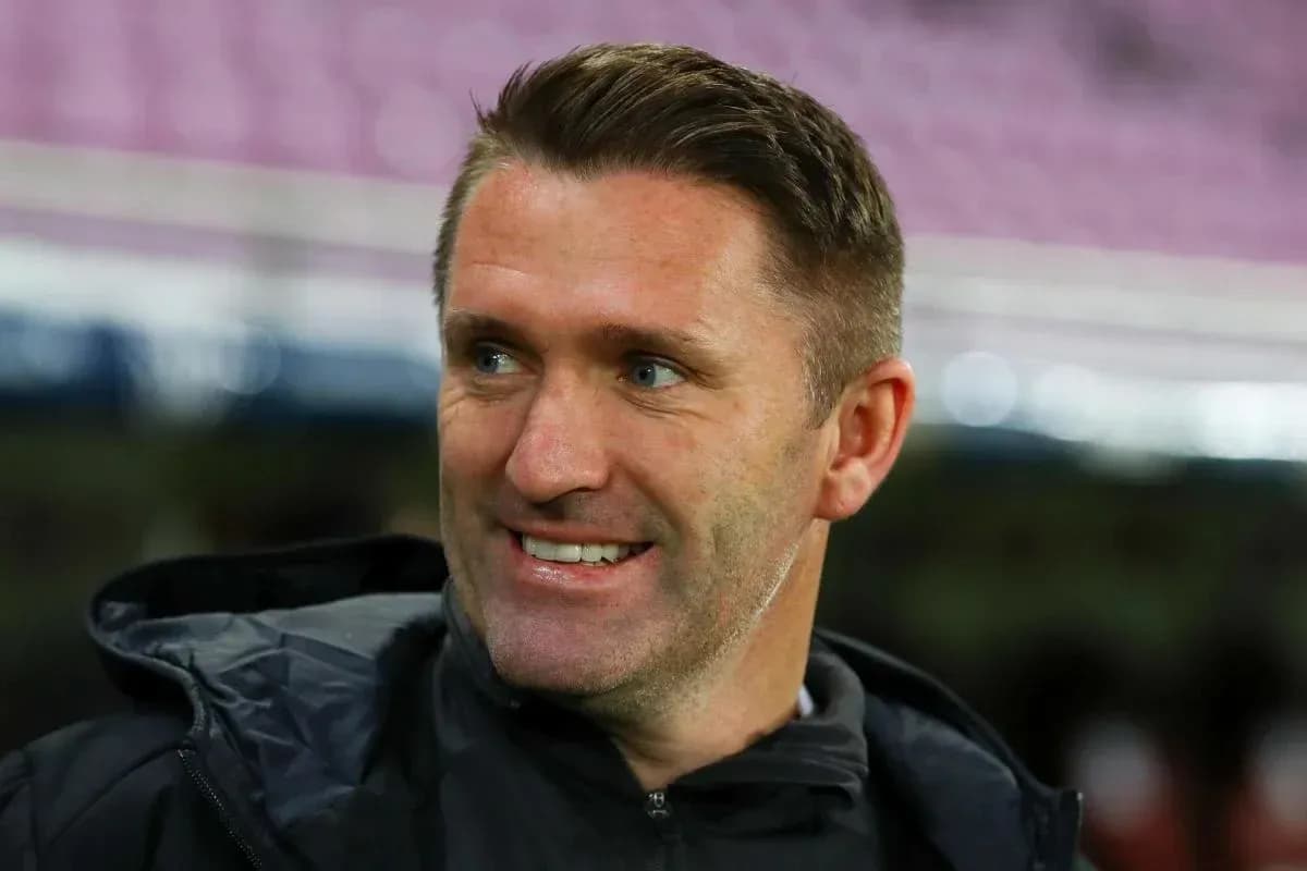 Coach smiling during a match warm-up