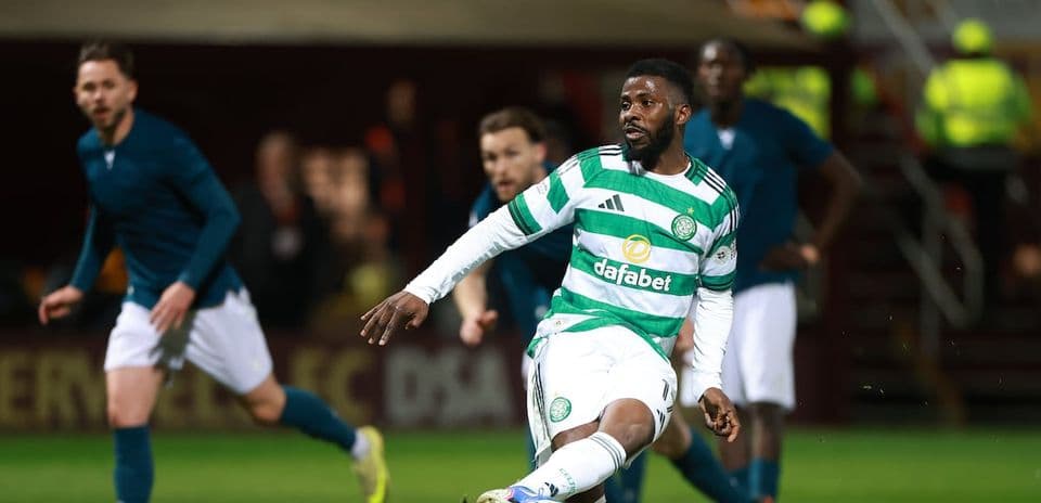 Celtic player kicking ball during match action