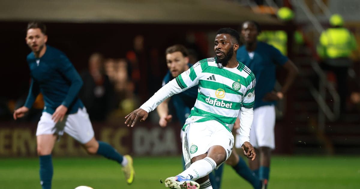 Celtic player kicking ball during match action