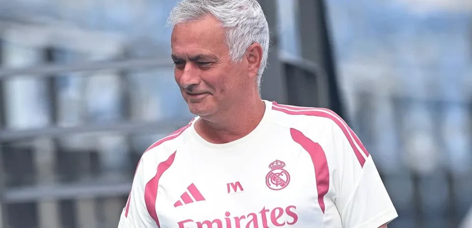 Coach wearing Real Madrid training gear on field