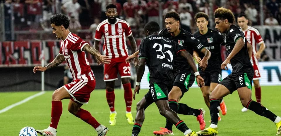 Olympiakos Piraeus player dribbling against NEC Nijmegen
