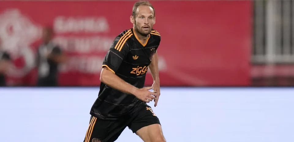 Player running during a match in black kit
