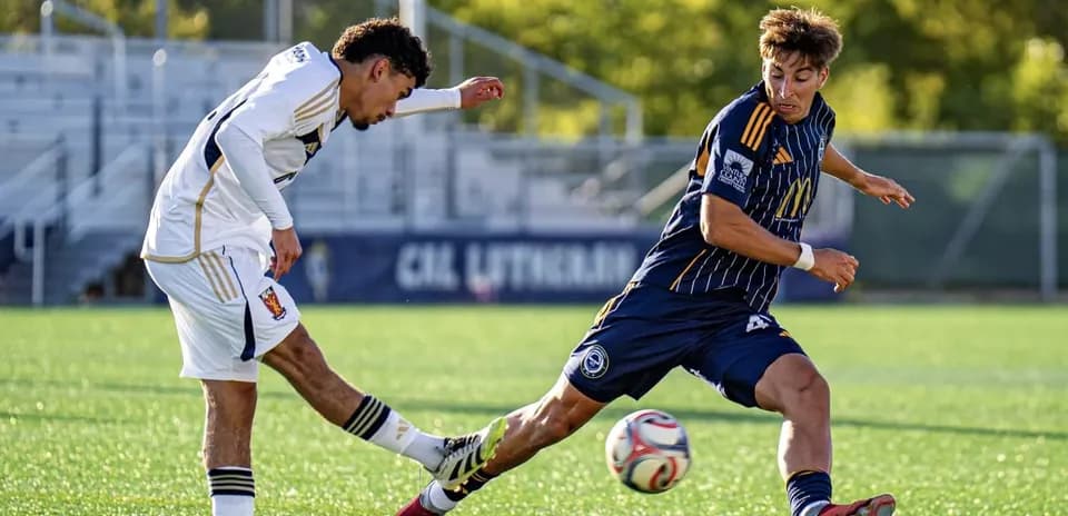 Player tackling opponent during MLS Next Pro match