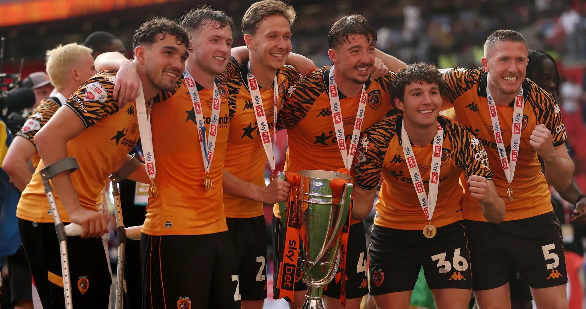 Players celebrating with trophy after championship victory