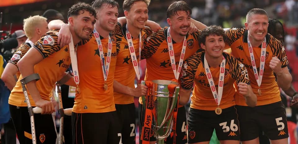 Players celebrating with trophy after championship victory