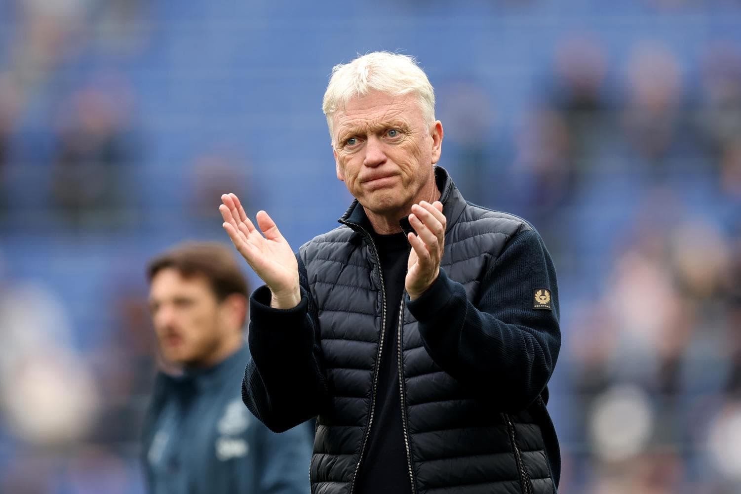 Manager applauding during match warm-up on field