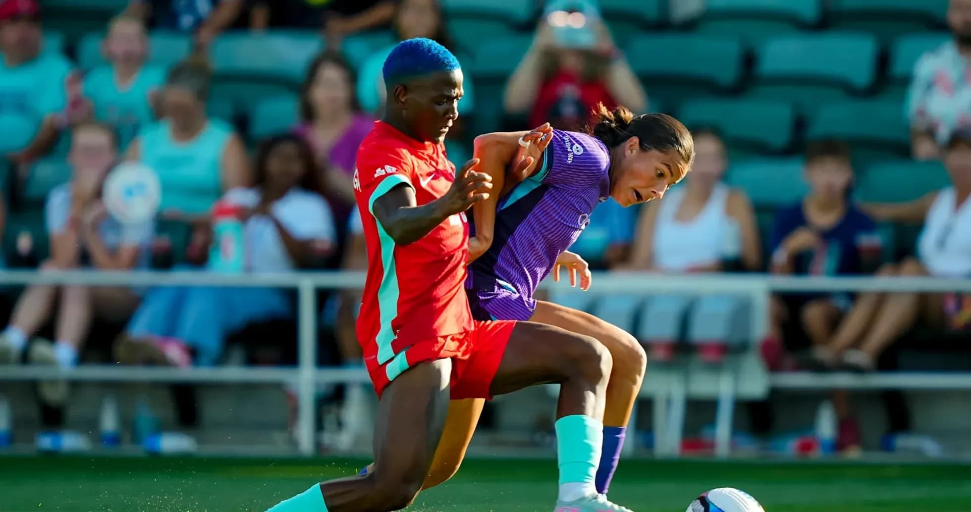 Player competing for the ball in NWSL match