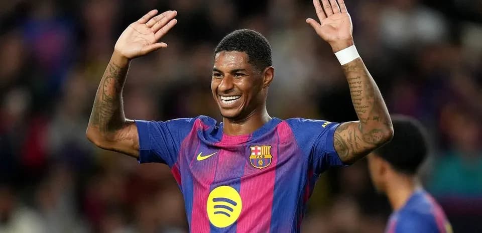 Player celebrating with hands raised on the field