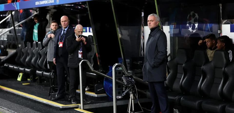 Manager observing from the bench during UEFA Champions League match
