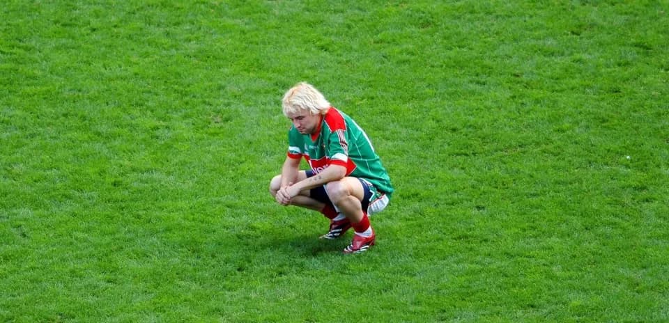 Player squatting on the field during match