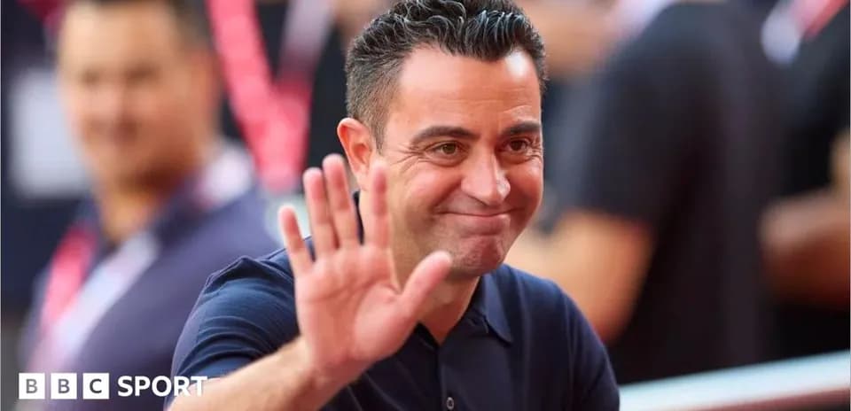 Coach waving while smiling at an event