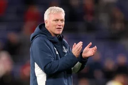 Manager applauding during a match on the sideline